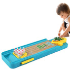 Children's toy set with a bowling lane and frog mechanism, next to its packaging.